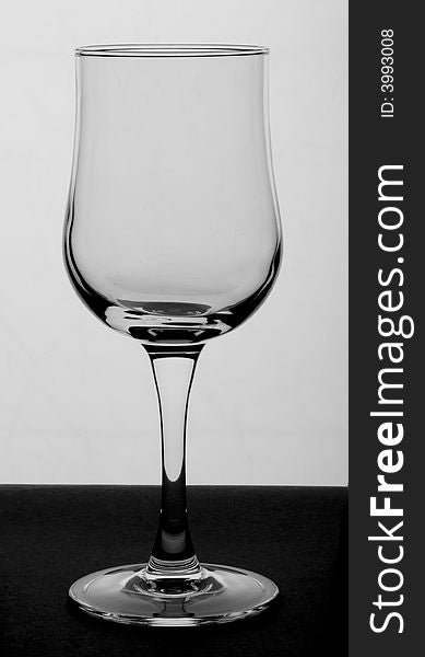 Wine Glass in studio. Monochrome photography. White background and wine glass in the front.