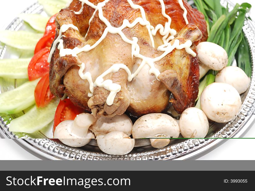 Grill chicken with vegetables on silver plate