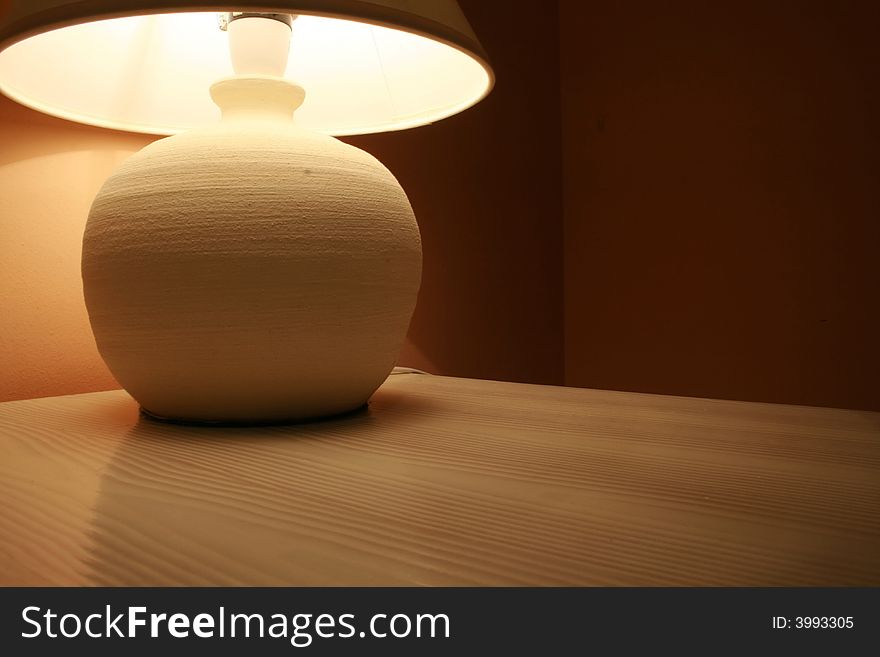 Lamp on a wooden cabinet in a hotel room