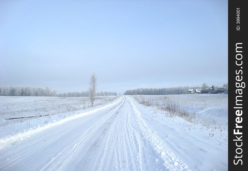 Snowly road in sunny day and nobody