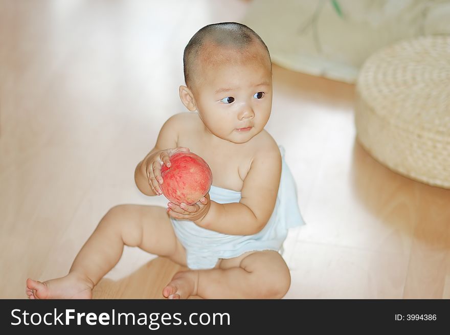 Little boy with a red peach in hand. Little boy with a red peach in hand