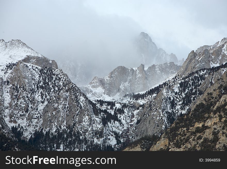Mt. Whitney shrouded in clouds during winter. Mt. Whitney shrouded in clouds during winter