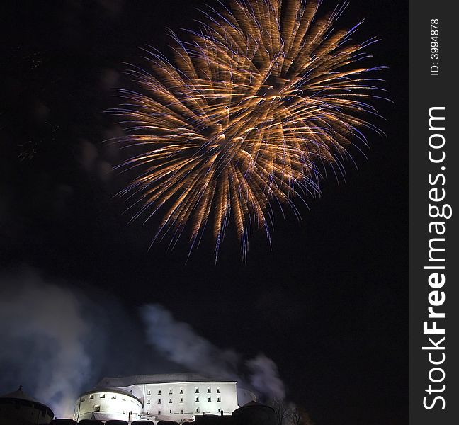 Fireworks on the New Year's Eve in Kufstein (Austria), exploding over the old castle (Festung) on a hill overlooking the town. Fireworks on the New Year's Eve in Kufstein (Austria), exploding over the old castle (Festung) on a hill overlooking the town