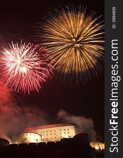 Fireworks on the New Year's Eve in Kufstein (Austria), exploding over the old castle (Festung) on a hill overlooking the town. Fireworks on the New Year's Eve in Kufstein (Austria), exploding over the old castle (Festung) on a hill overlooking the town