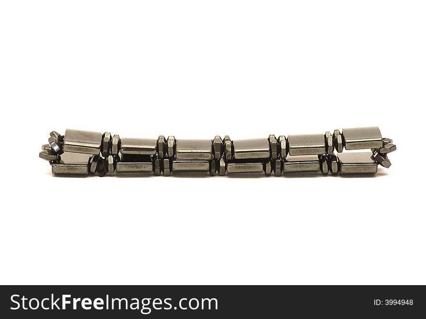 Close-up view of a magnetic bracelet which is supposed to help relieve arthritis, laying flat on its back, isolated against a white background. Close-up view of a magnetic bracelet which is supposed to help relieve arthritis, laying flat on its back, isolated against a white background