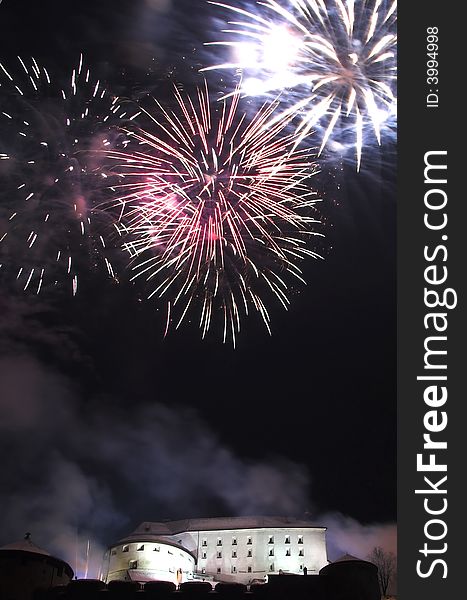 Fireworks on the New Year's Eve in Kufstein (Austria), exploding over the old castle (Festung) on a hill overlooking the town. Fireworks on the New Year's Eve in Kufstein (Austria), exploding over the old castle (Festung) on a hill overlooking the town