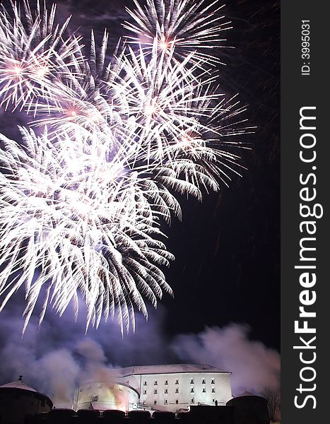 Fireworks on the New Year's Eve in Kufstein (Austria), exploding over the old castle (Festung) on a hill overlooking the town. Fireworks on the New Year's Eve in Kufstein (Austria), exploding over the old castle (Festung) on a hill overlooking the town