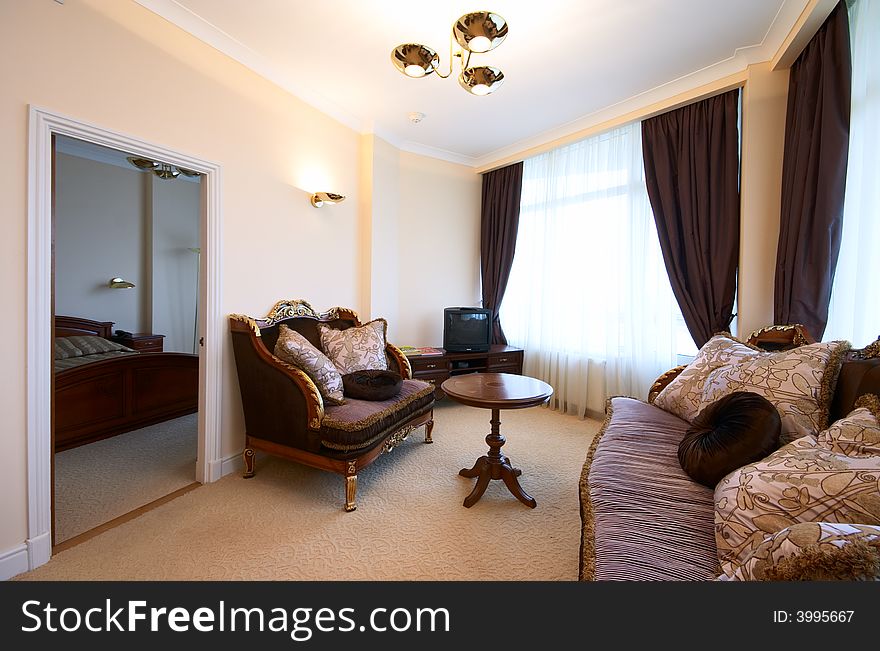 Drawing-room interior with couch and arm-chairs