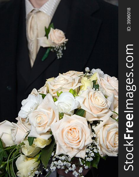 Bridegroom keeps bouquet for bride