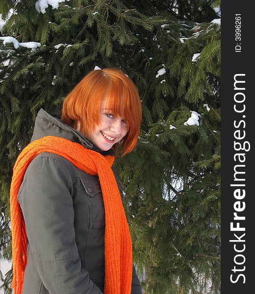 Red-haired girl with orange scarf and green fir