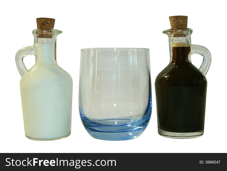 Two small decanters whith milk and coffee. It is isolated on a white background