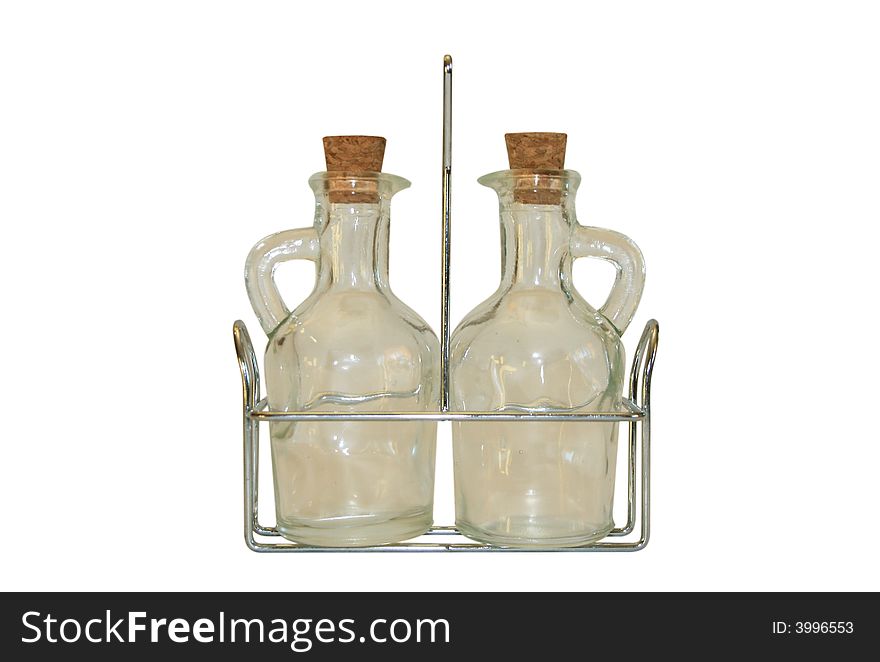 Two small decanters on a metal support. It is isolated on a white background