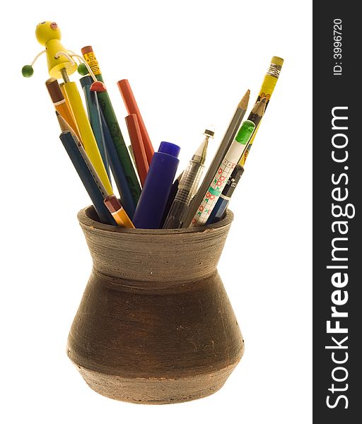 Various pencils in the hand-made jug. Various pencils in the hand-made jug