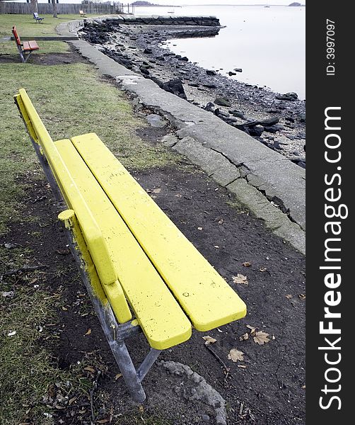 Colorful benches overlooking a river on a windless day. Colorful benches overlooking a river on a windless day