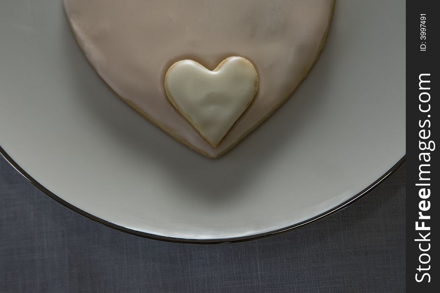 Valentine or wedding cookie on a white china plate. Valentine or wedding cookie on a white china plate.