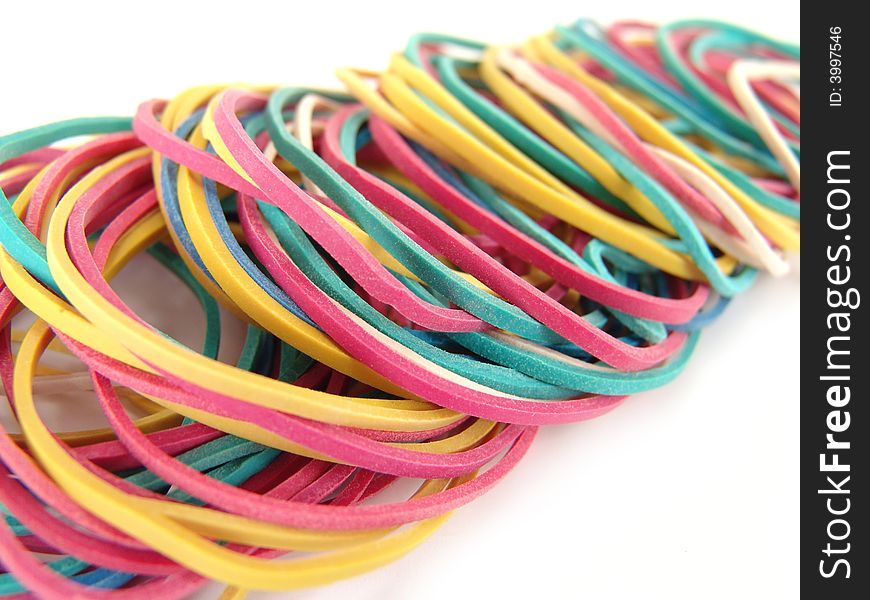 Close up of multi-colored rubber bands on white background