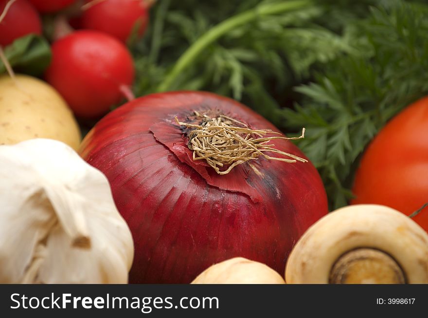 Red onion on vegetables background