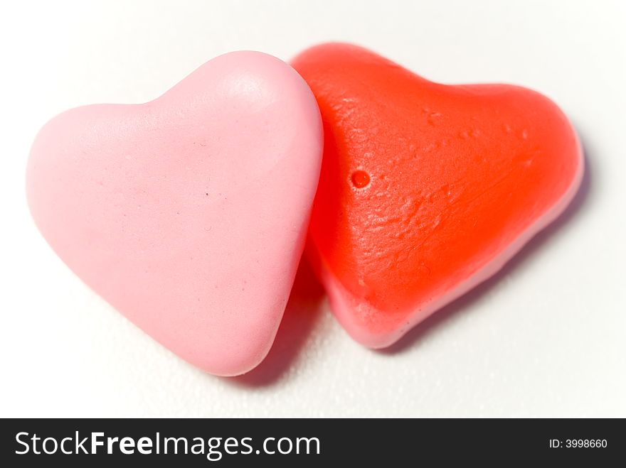 Close up red and pink candy hearts isloated on white. Close up red and pink candy hearts isloated on white