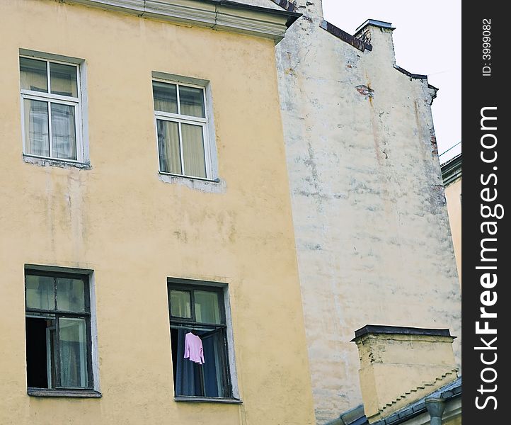 Dress hanging to dry in open window of old building. Dress hanging to dry in open window of old building