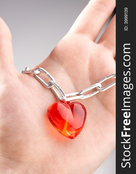 Heart on a chain wound on a palm. Heart on a chain wound on a palm