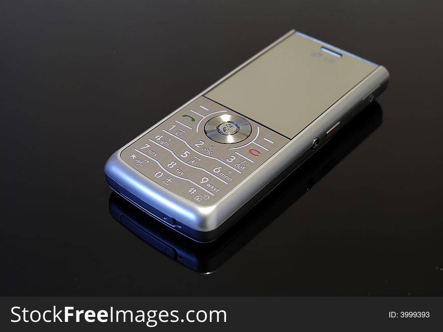 Silver mobile phone in black background. Silver mobile phone in black background.