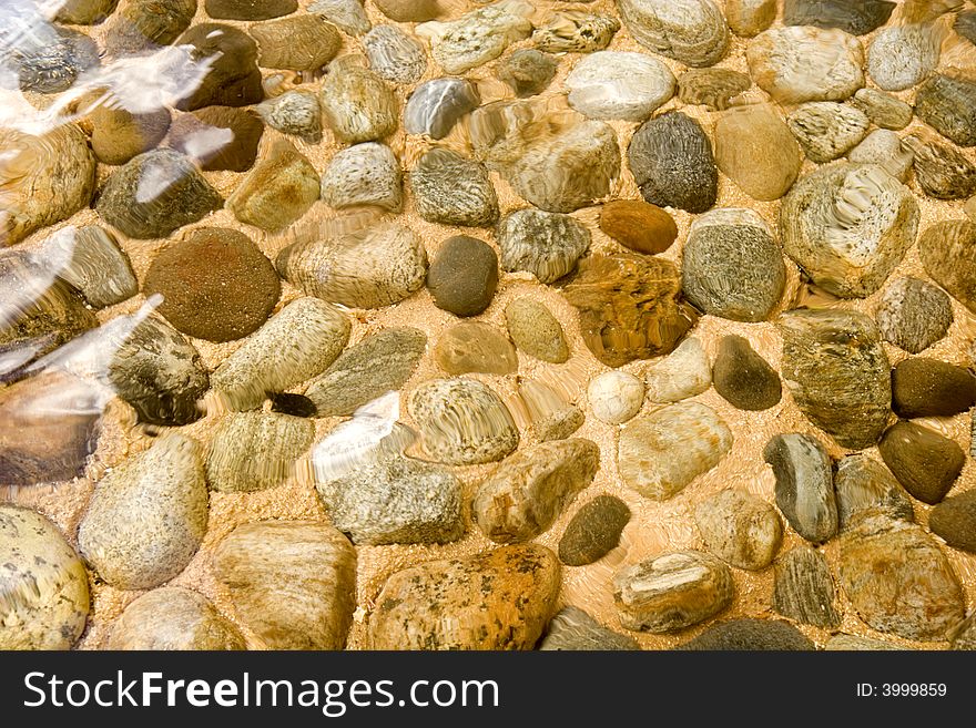 Colorful River Rocks under the flow of clear water. Colorful River Rocks under the flow of clear water