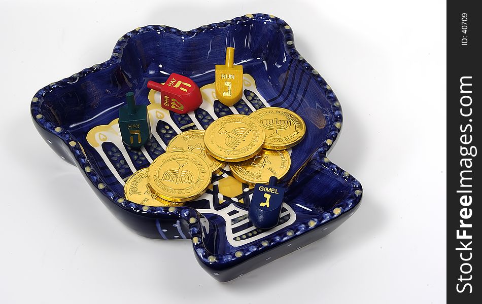 Photo of a Chanukah Bowl With Dreidels and Gelt. Photo of a Chanukah Bowl With Dreidels and Gelt.