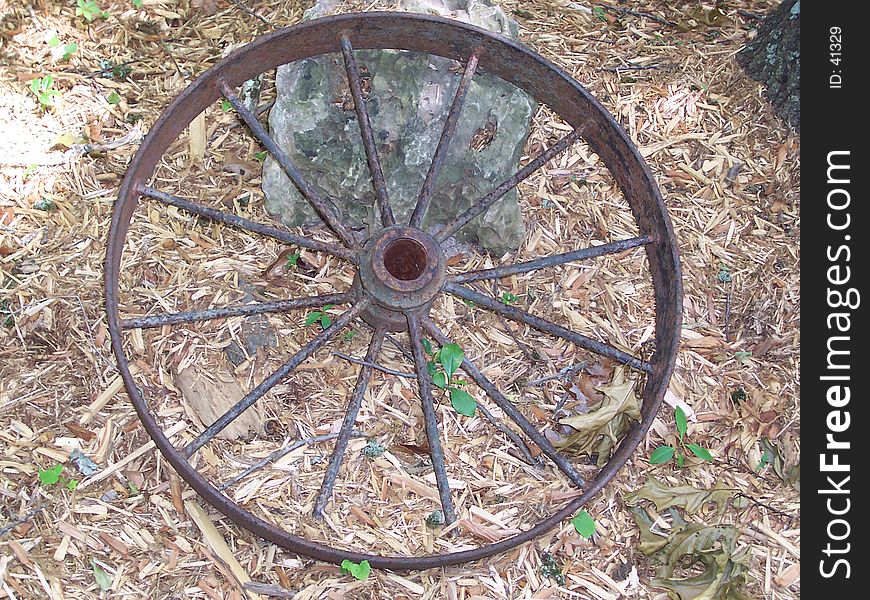 A soft image of a very old and rusty wheel from a wagon. A soft image of a very old and rusty wheel from a wagon.