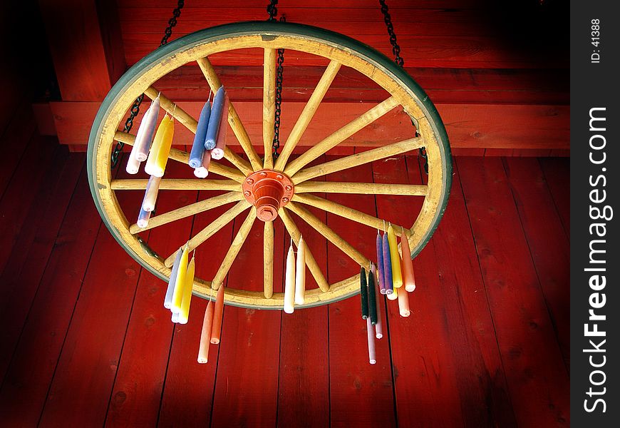 Candles hung to dry on wagon wheel