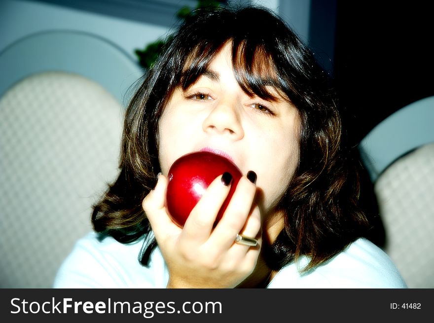 Photo of a Woman Eating an Apple With Soft Blur. Photo of a Woman Eating an Apple With Soft Blur.