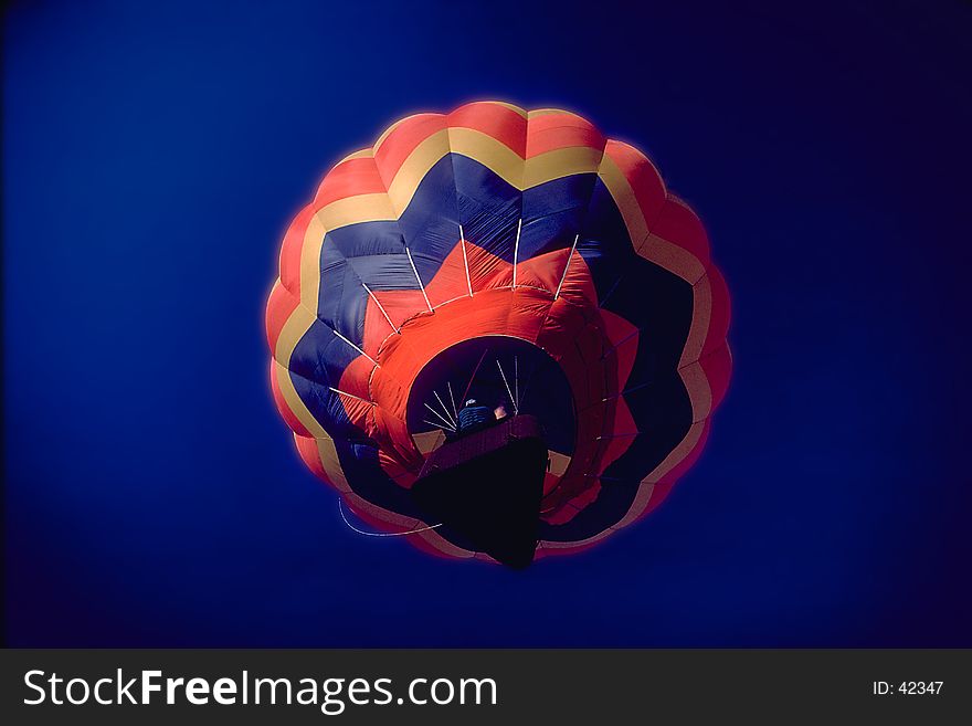 Balloon rising up through a dark blue sky. Balloon rising up through a dark blue sky.