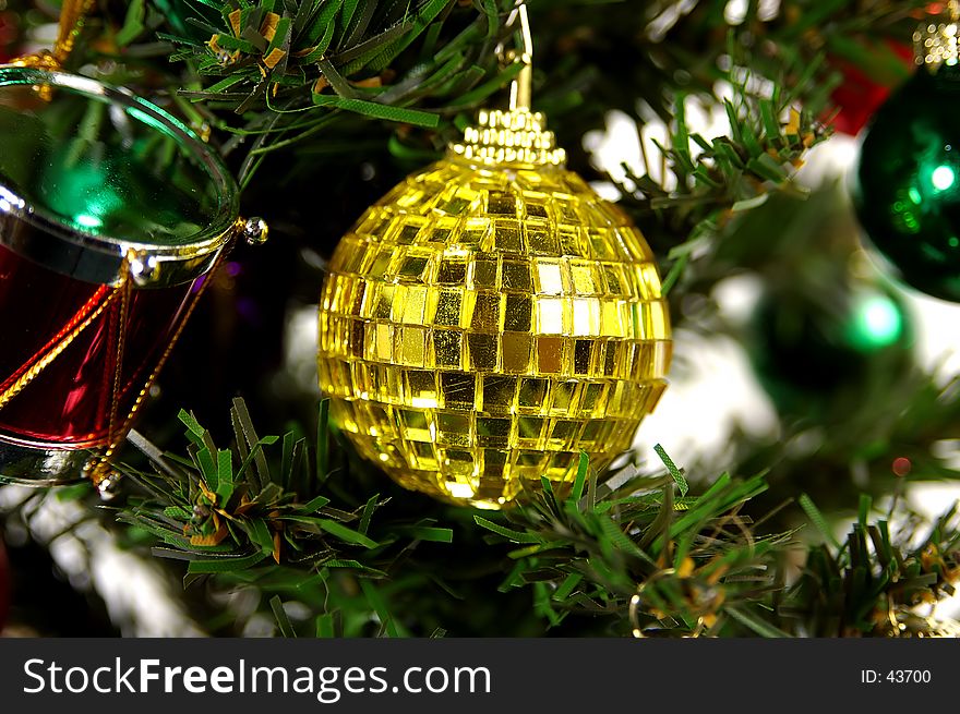 Photo of a Yellow Glass Christmas Ornament on a Tree. Photo of a Yellow Glass Christmas Ornament on a Tree.