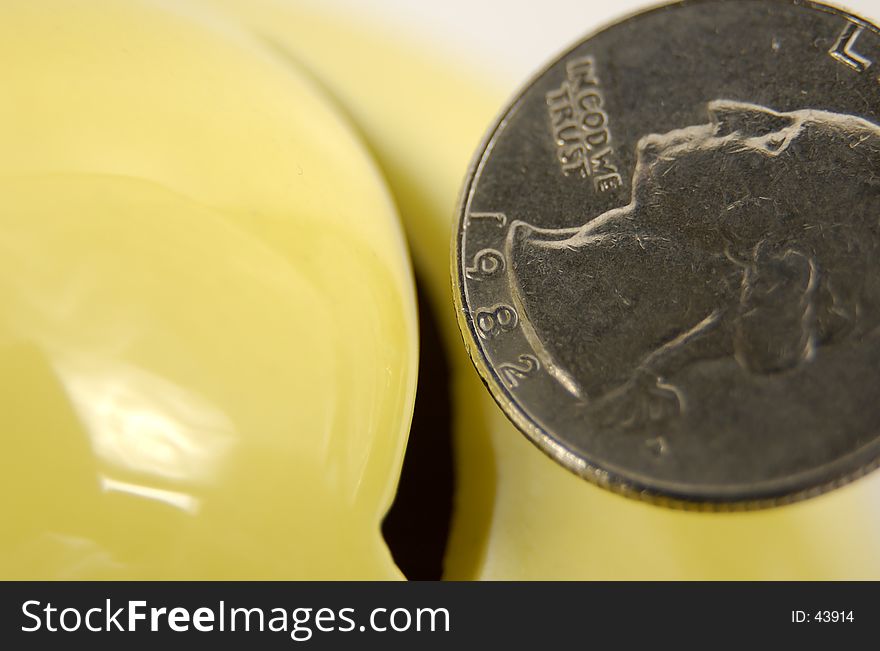 Photo of a Quarter Being Inserted Into a Piggy Bank. Photo of a Quarter Being Inserted Into a Piggy Bank.