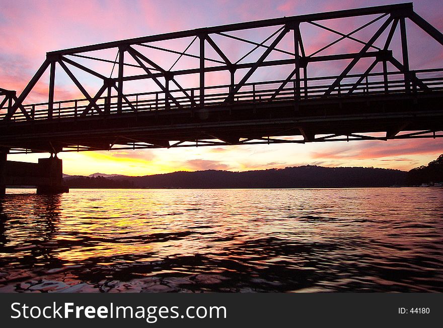 Sunset behind an iron bridge