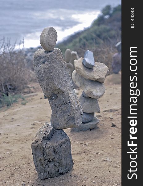 Balanced rocks on cliff overlooking beach