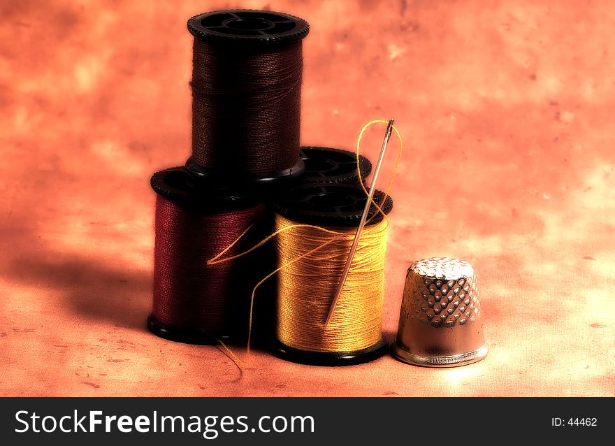 Photo of Needle and Thread Spools With Color and Blur Effect. Photo of Needle and Thread Spools With Color and Blur Effect.