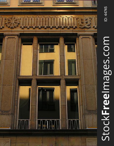 The high window of an old wilhelminian building with mellow reflections of other windows. The high window of an old wilhelminian building with mellow reflections of other windows