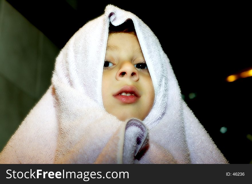 Photo of a Child With Towel Over His Head. Saturated Colors and Soft Diffused look. Photo of a Child With Towel Over His Head. Saturated Colors and Soft Diffused look.
