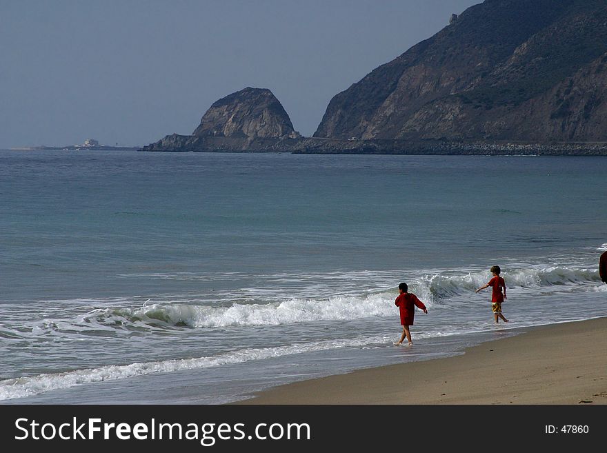 Kids playing on the beach, on the California coast.