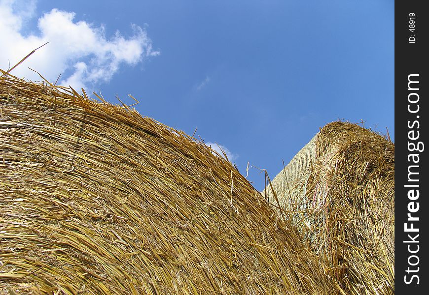 Hay bale roles in front of blue sky. Hay bale roles in front of blue sky.