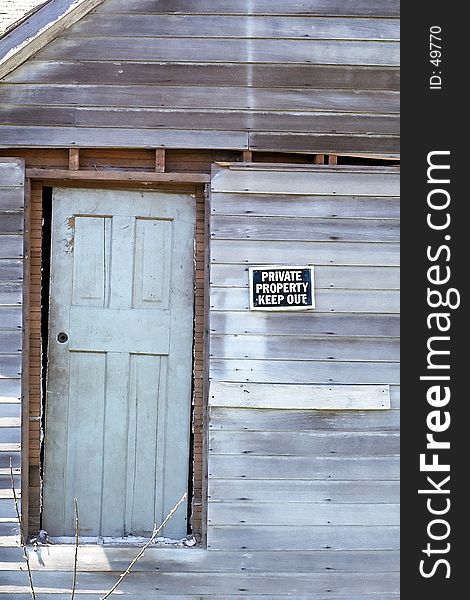 Sign posted on old, rundown house. Sign posted on old, rundown house.