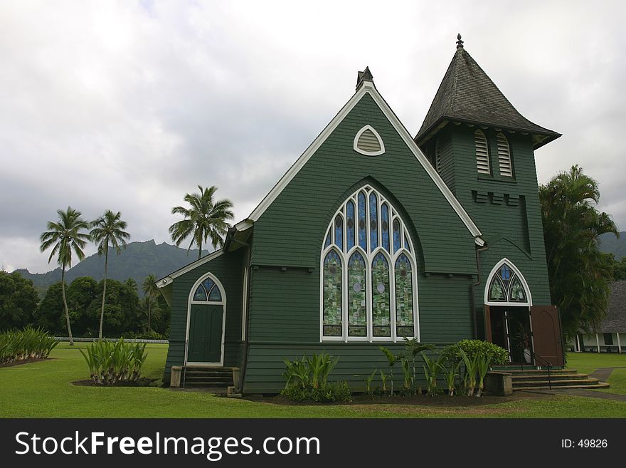 Small green church with mountain and palm trees in background. Small green church with mountain and palm trees in background