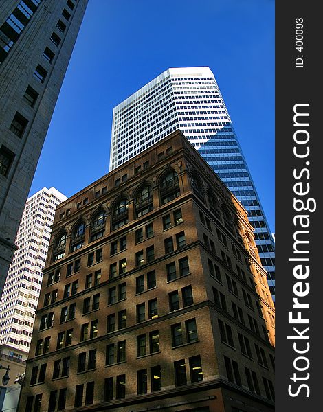 Older San Francisco building surrounded by taller more modern buildings. Older San Francisco building surrounded by taller more modern buildings