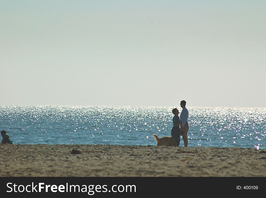 Couple on the beach with their dog. Couple on the beach with their dog