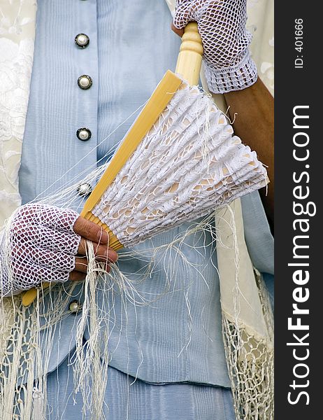 Woman in period clothes holding fan and wearing lacy gloves. Woman in period clothes holding fan and wearing lacy gloves