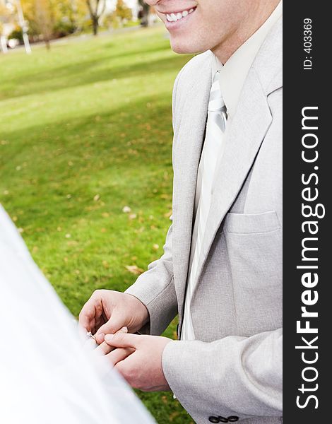 Happy man, places ring on bride's finger. Happy man, places ring on bride's finger