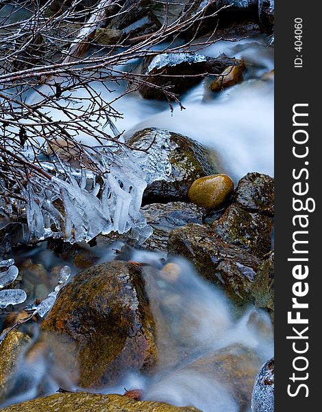 An icy mountain stream flows through icy channels. An icy mountain stream flows through icy channels.