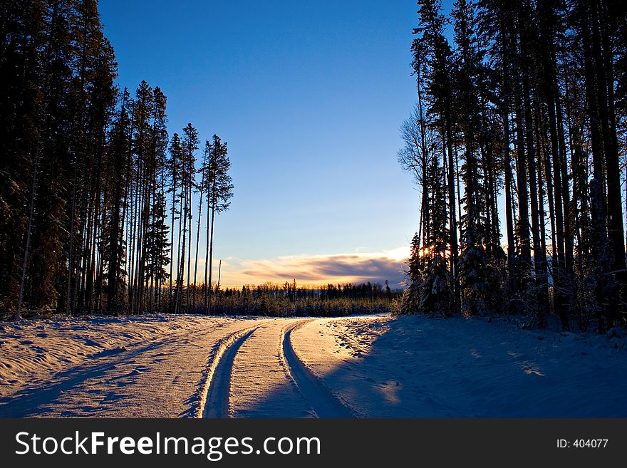 A snow covered backroad at sunrise. A snow covered backroad at sunrise.
