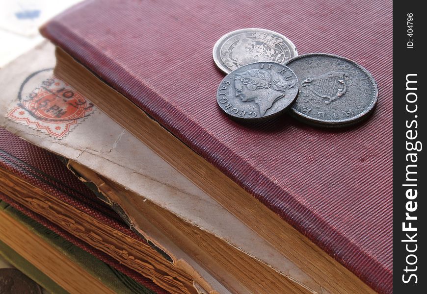 Stack of books with coins