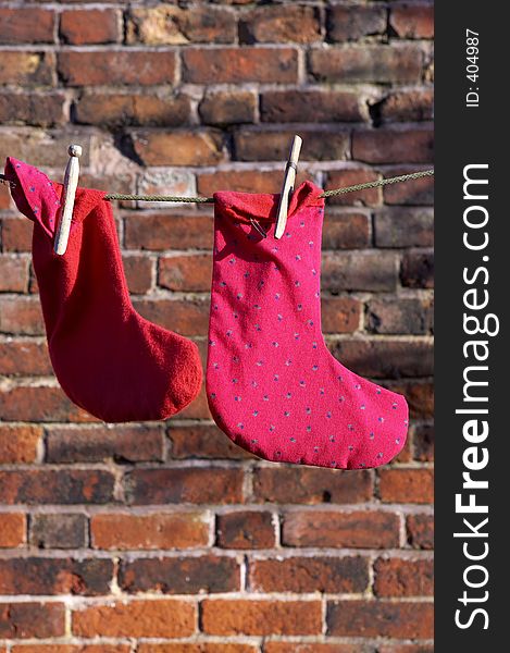 Two socks drying on a washing line